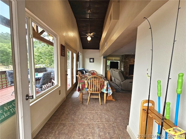 sunroom / solarium with lofted ceiling, a fireplace, and ceiling fan