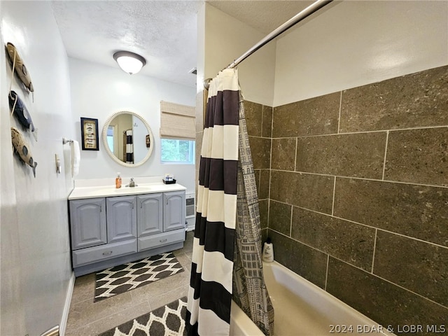 bathroom featuring vanity, shower / tub combo, and a textured ceiling