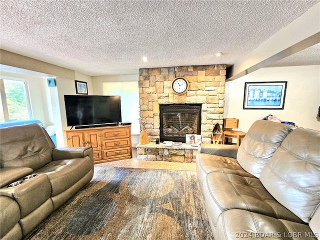 living room featuring a fireplace and a textured ceiling