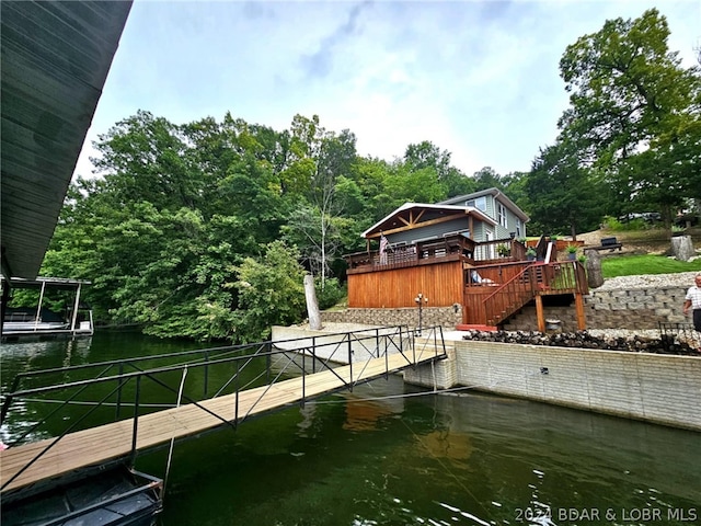 view of dock with a deck with water view