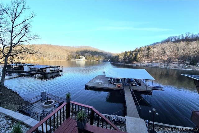 dock area with a water view and an outdoor fire pit