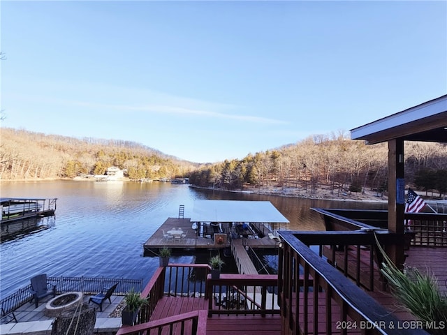 dock area with a deck with water view and an outdoor fire pit