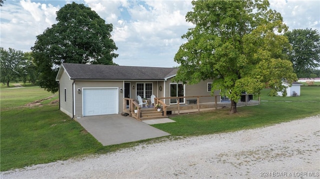 ranch-style house with a garage and a front lawn