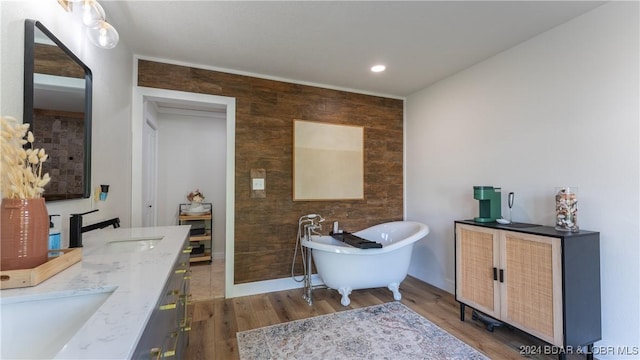 bathroom with a tub to relax in, hardwood / wood-style floors, and vanity