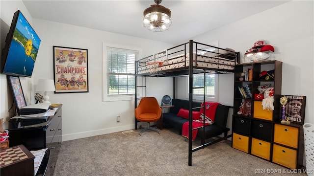 carpeted bedroom featuring multiple windows