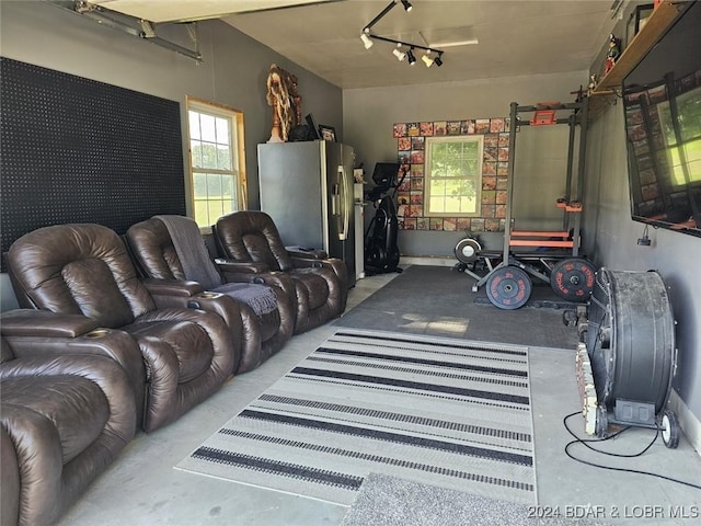 garage with stainless steel refrigerator with ice dispenser