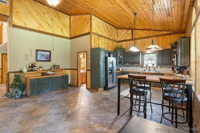 kitchen featuring wooden ceiling, stainless steel fridge with ice dispenser, high vaulted ceiling, butcher block countertops, and decorative light fixtures