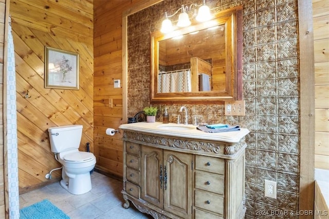 bathroom featuring tile patterned floors, vanity, wooden walls, toilet, and curtained shower