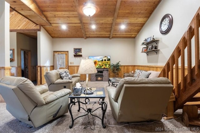 carpeted living room with lofted ceiling with beams, wood ceiling, and wooden walls