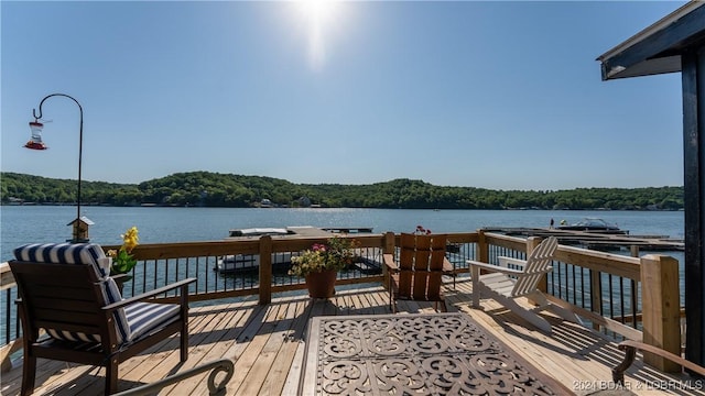 view of dock with a deck with water view