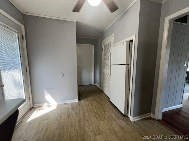 hallway featuring hardwood / wood-style flooring and ornamental molding