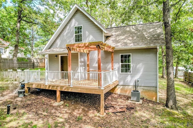 back of property featuring a pergola, central air condition unit, and a deck