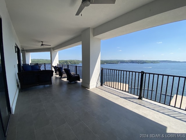 exterior space with a water view, an outdoor living space, and ceiling fan