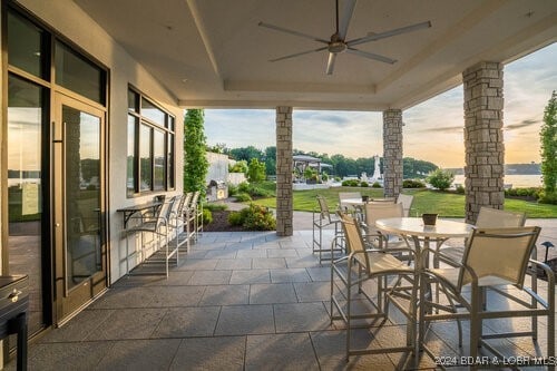 patio terrace at dusk featuring ceiling fan