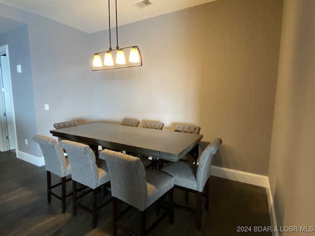 dining space featuring dark wood-type flooring