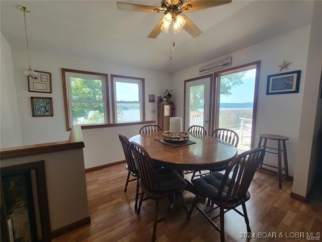 dining space featuring wood-type flooring and ceiling fan