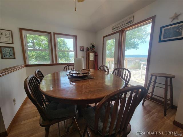 dining area with plenty of natural light, wood finished floors, and baseboards