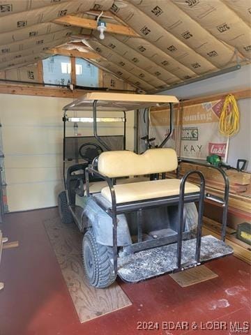 bedroom featuring a garage and lofted ceiling