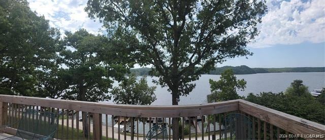 wooden deck featuring a water view