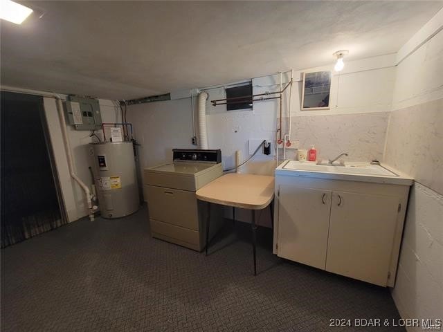 washroom featuring washer / dryer, sink, electric water heater, and electric panel