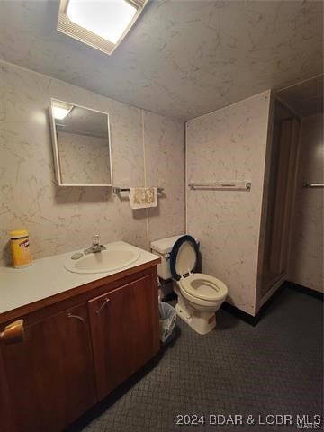 bathroom with tile patterned flooring, toilet, and vanity