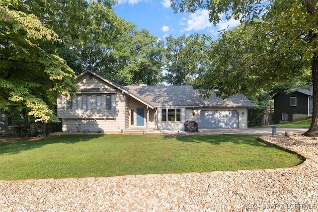 view of front of house with a garage and a front lawn