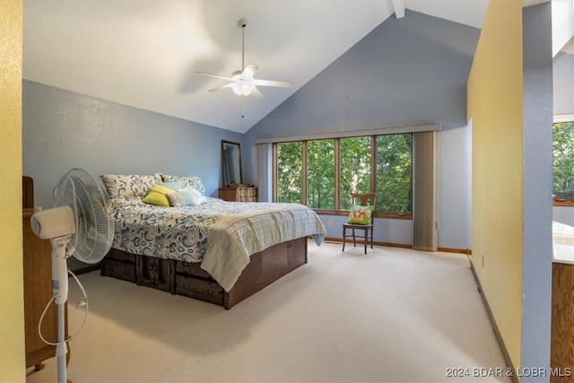 carpeted bedroom featuring ceiling fan and high vaulted ceiling