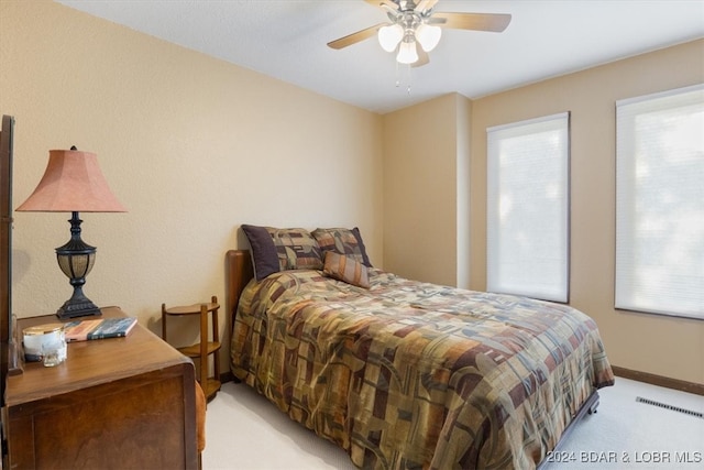 bedroom with ceiling fan and light colored carpet