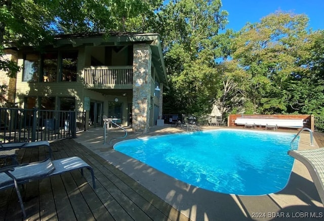 view of swimming pool featuring a deck