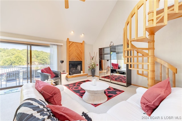 living room with a fireplace, carpet flooring, and high vaulted ceiling