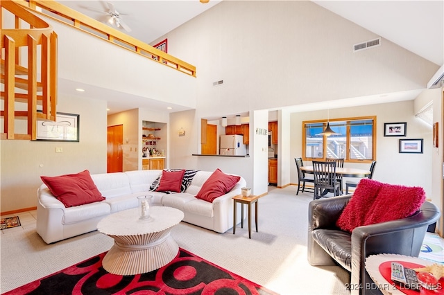 living room with carpet, ceiling fan, and high vaulted ceiling