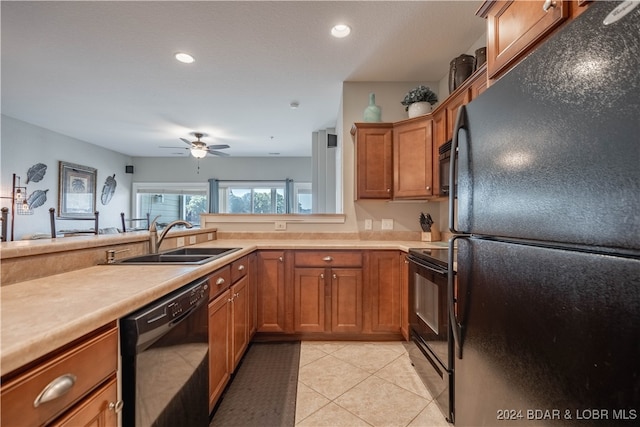 kitchen with sink, light tile patterned flooring, black appliances, and ceiling fan