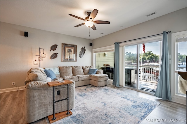 living room featuring hardwood / wood-style flooring and ceiling fan