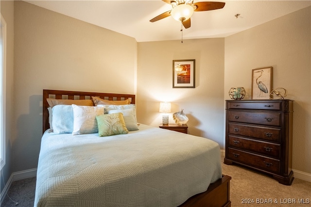 bedroom featuring light colored carpet and ceiling fan