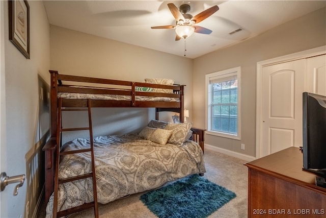 carpeted bedroom with a closet and ceiling fan