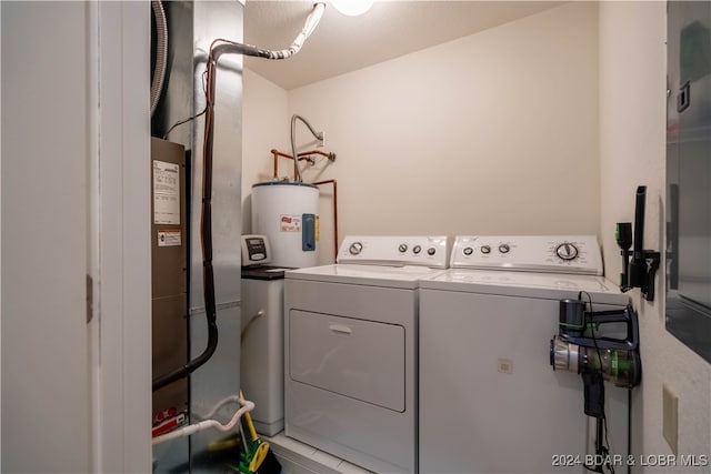 washroom featuring water heater and independent washer and dryer