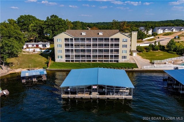 dock area featuring a water view and a lawn