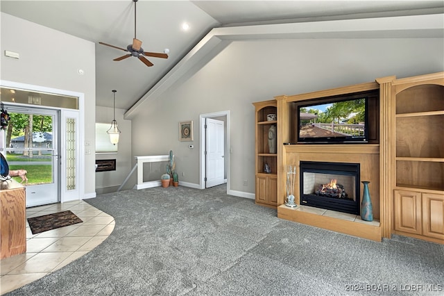 unfurnished living room featuring light carpet, a fireplace, ceiling fan, and high vaulted ceiling