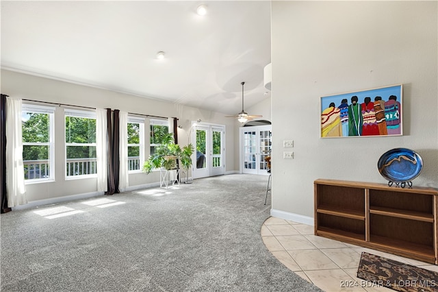 interior space featuring ceiling fan, light colored carpet, and plenty of natural light