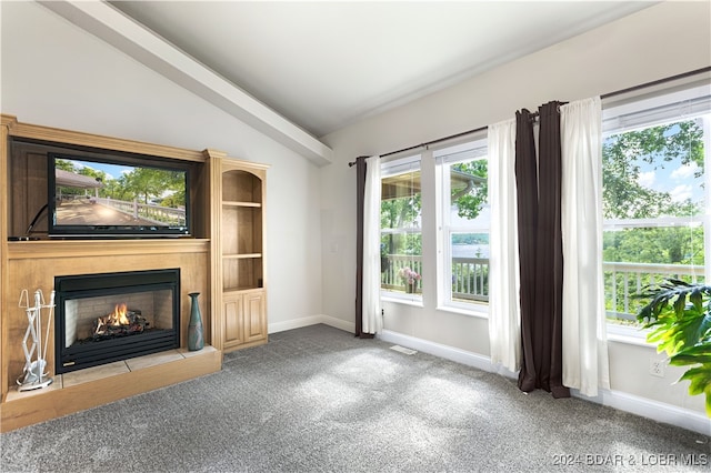 unfurnished living room with vaulted ceiling and light colored carpet