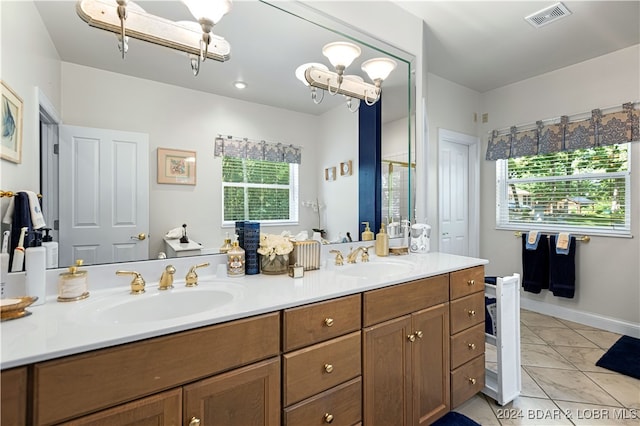 bathroom with tile patterned floors and double vanity