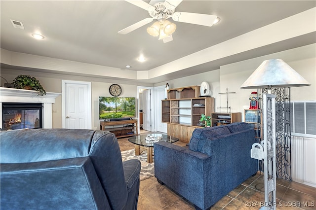 tiled living room featuring ceiling fan