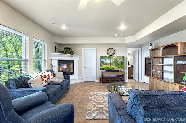 tiled living room with ceiling fan