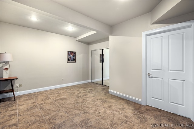 unfurnished bedroom with tile patterned flooring and a closet