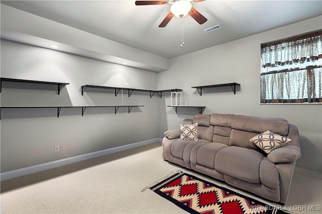 carpeted living area featuring baseboards, visible vents, and ceiling fan