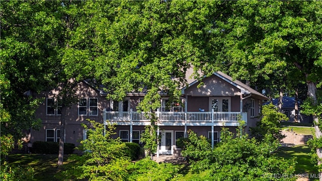 back of house featuring a balcony