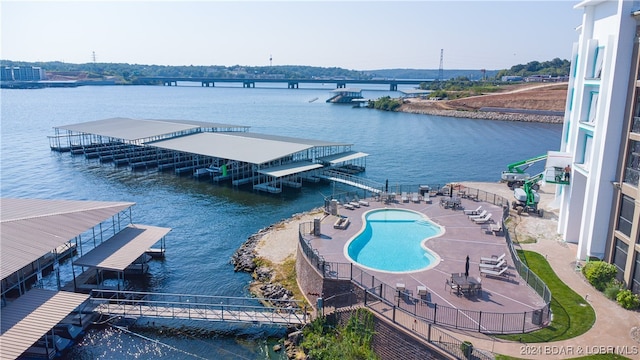 exterior space featuring a patio area, a community pool, and a water view