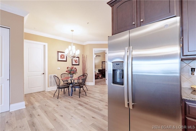 kitchen with dark brown cabinets, stone countertops, stainless steel refrigerator with ice dispenser, decorative light fixtures, and crown molding