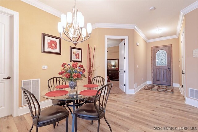 dining room featuring crown molding, a notable chandelier, and light hardwood / wood-style flooring