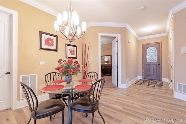 dining area with a notable chandelier, light hardwood / wood-style floors, and crown molding